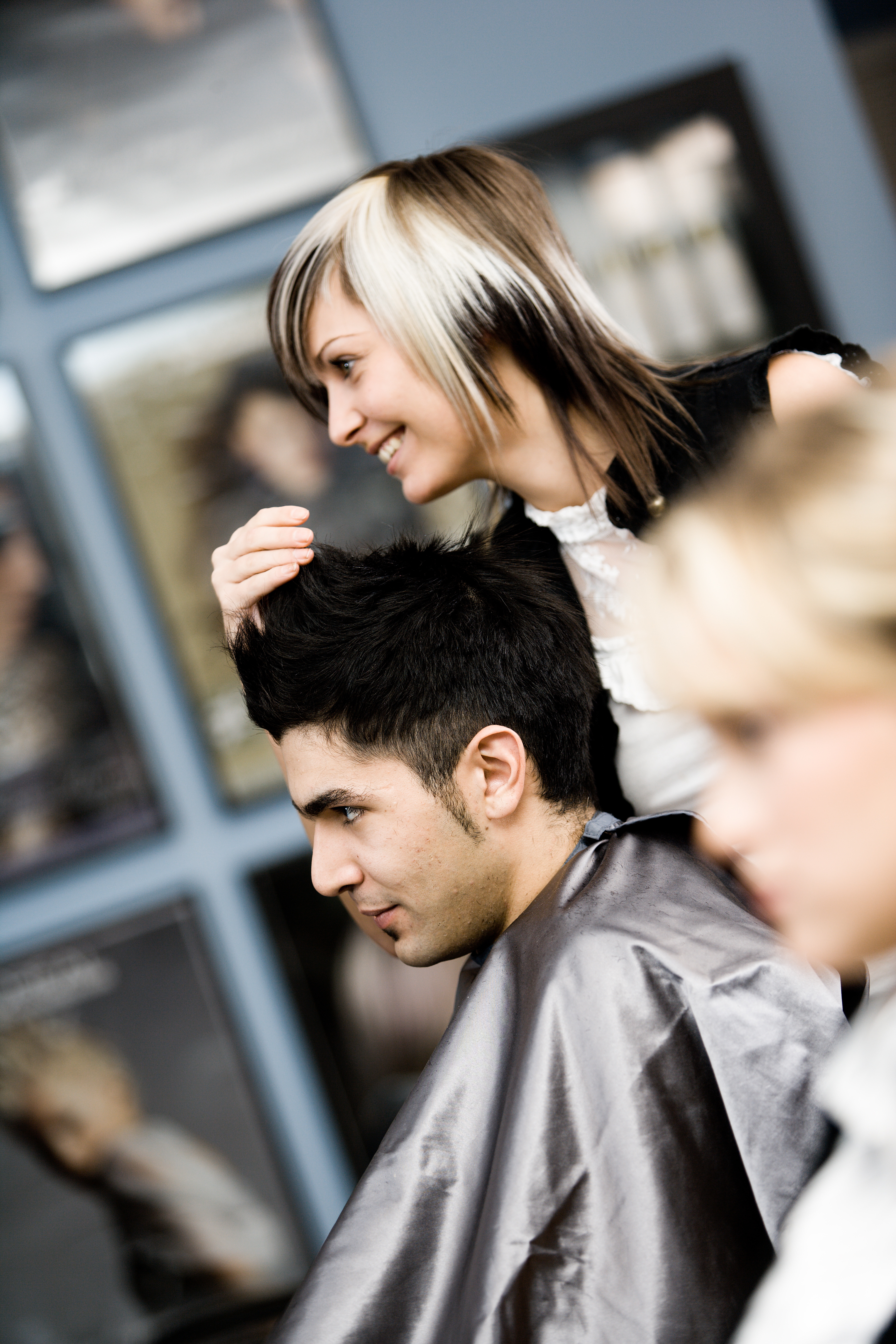 Hair stylist styling man's hair