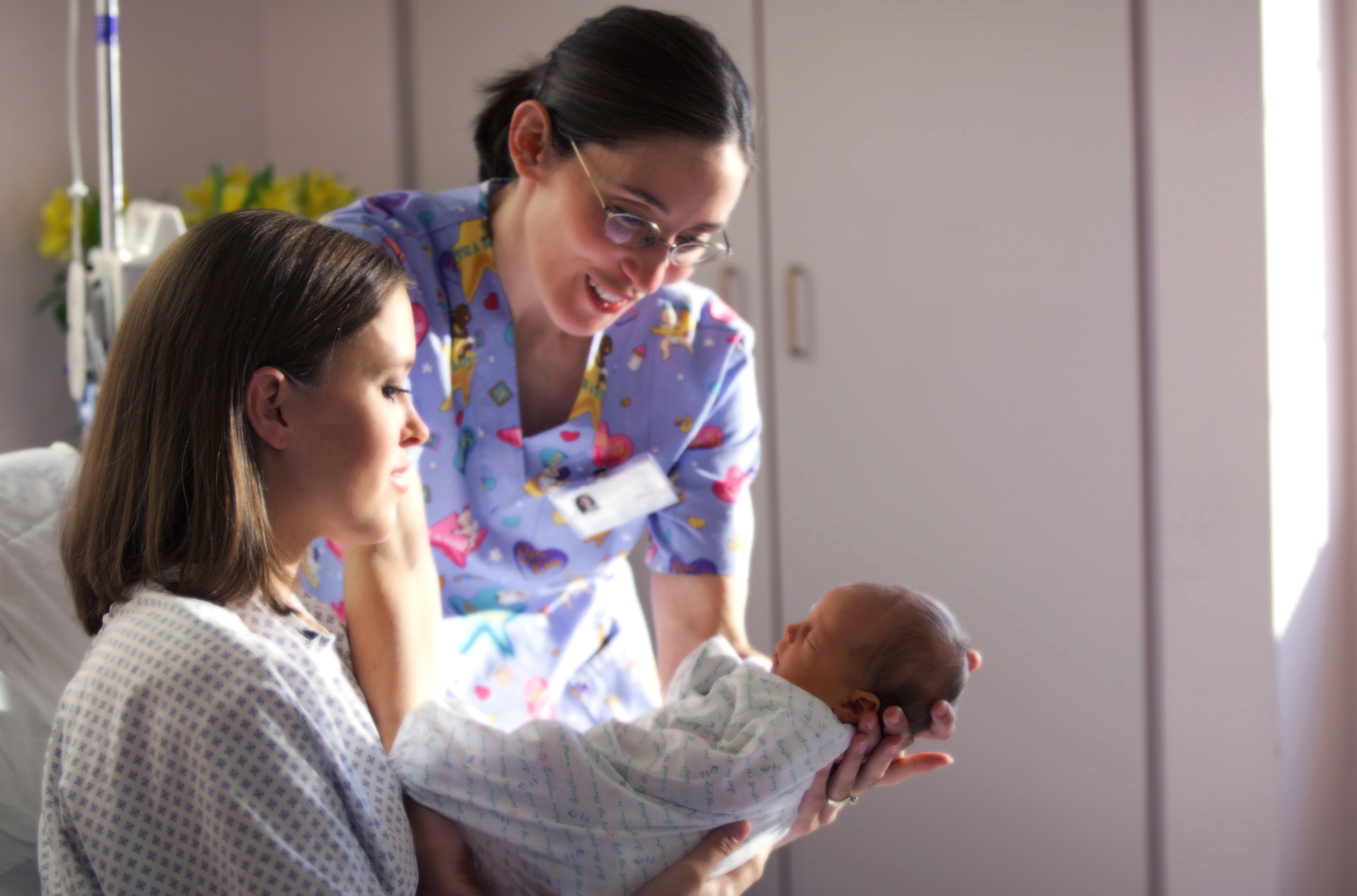 Baby with mom and nurse