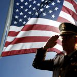 veteran-saluting-in-front-of-flag