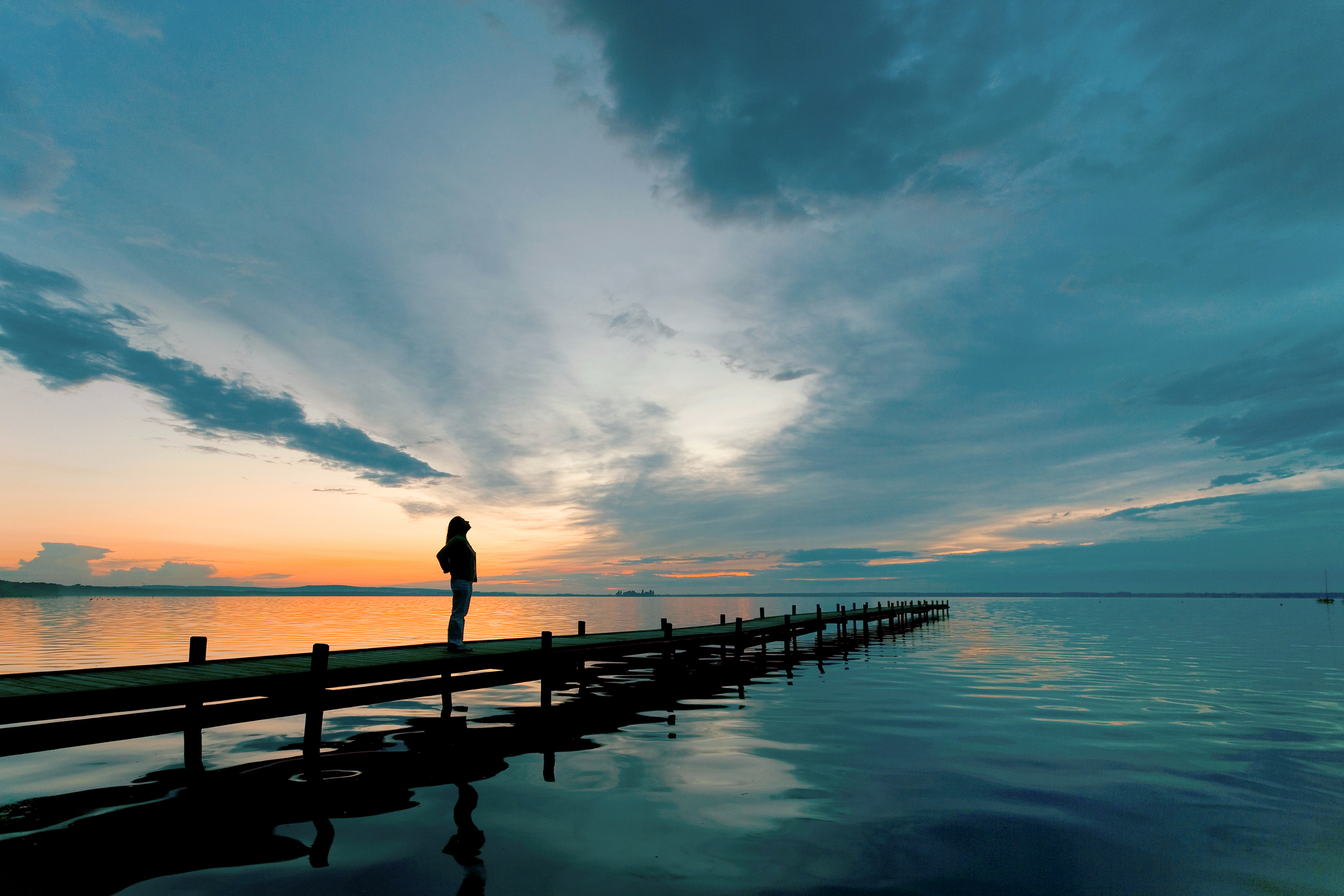 person on bridge at sunset