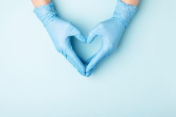heart made with hands in medical gloves